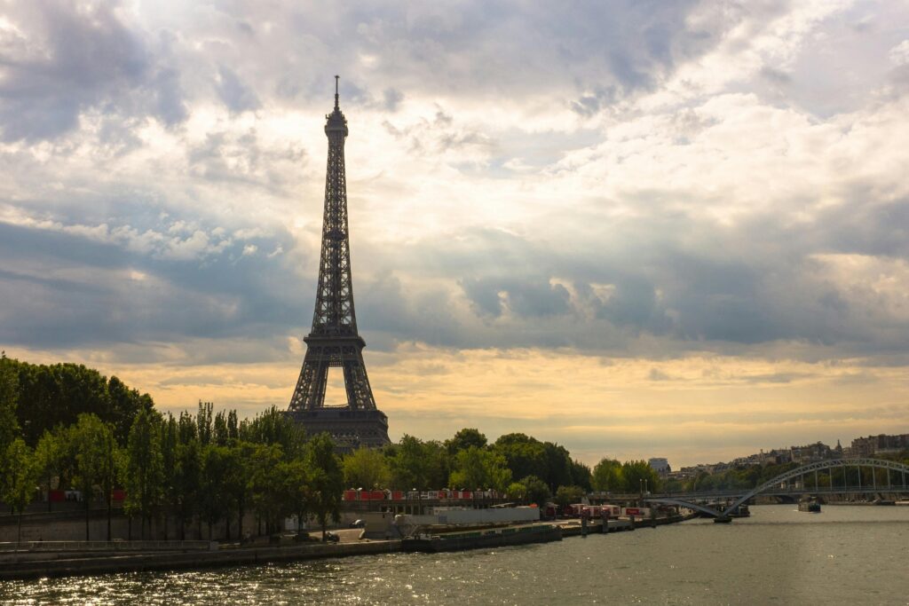 eiffel-tower-paris-france-tower-161853-161853 Stunning view of the Eiffel Tower at sunset with the River Seine and lush green trees.