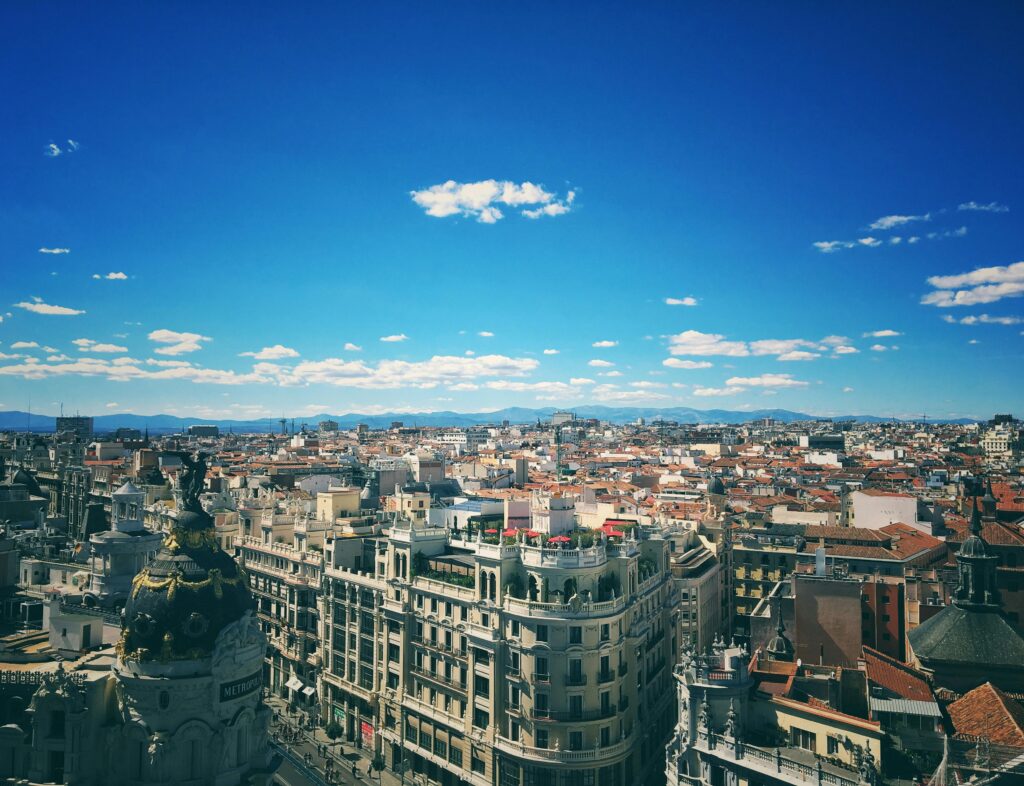 A breathtaking aerial view of Madrid's vibrant cityscape under a clear blue sky.